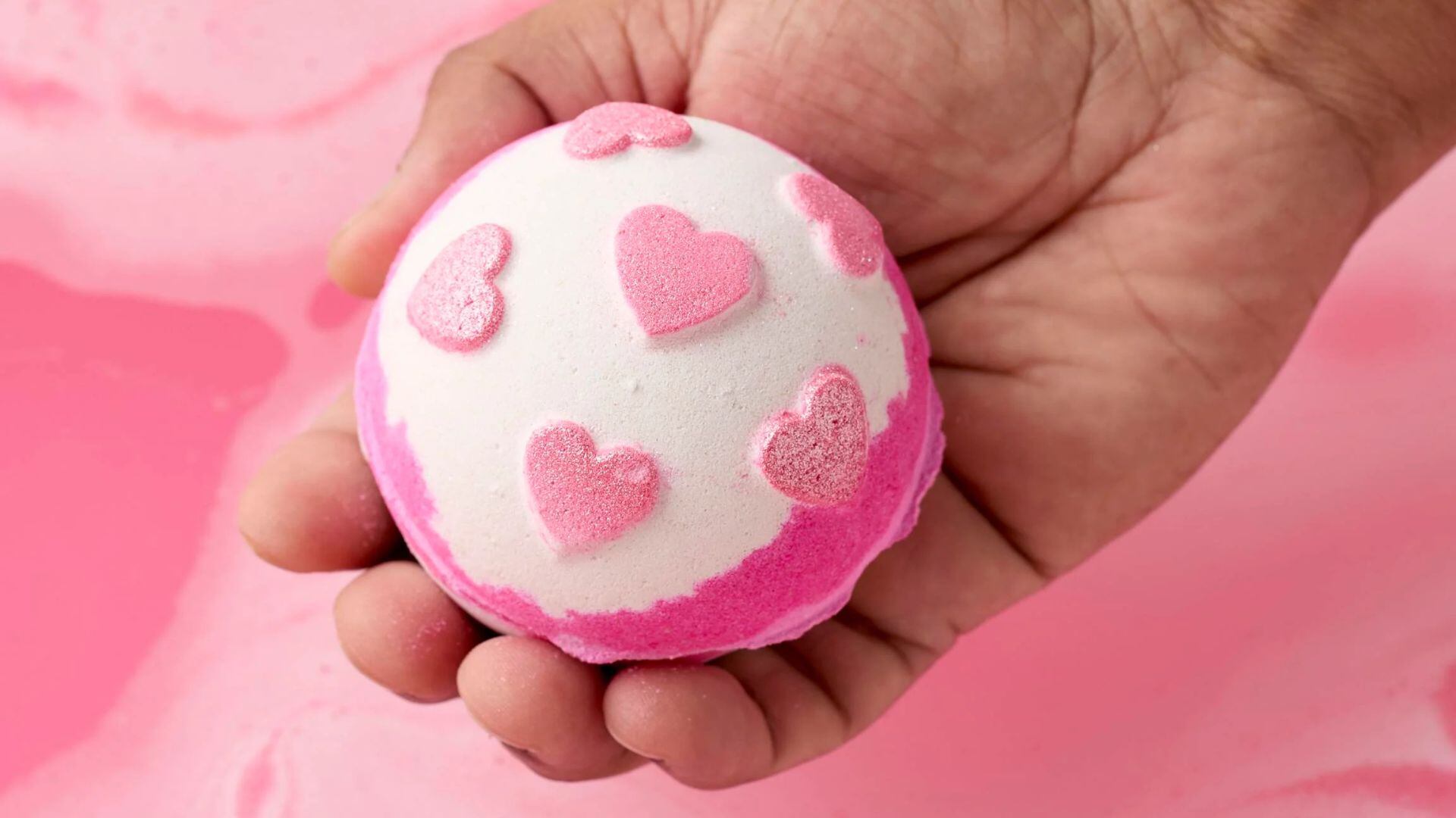 A person holding a LUSH bath bomb.