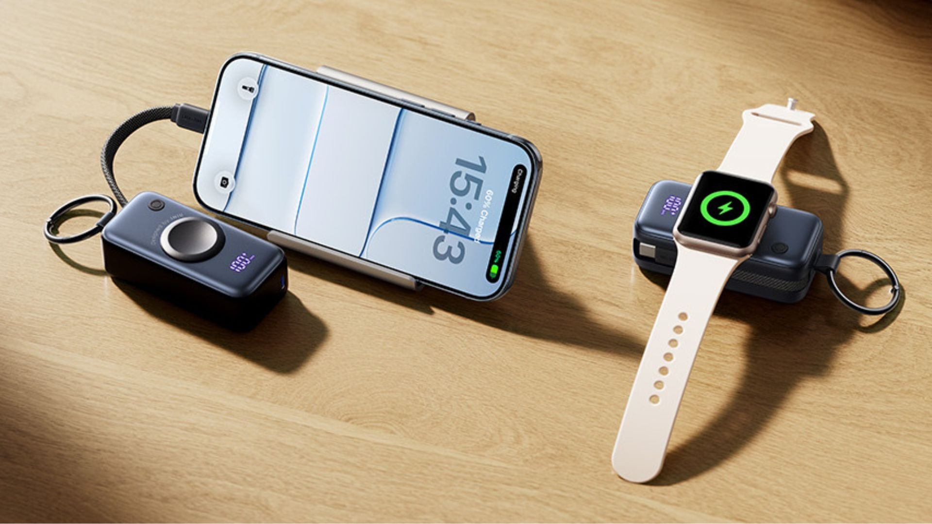 A phone and an Apple Watch are charging on portable chargers.