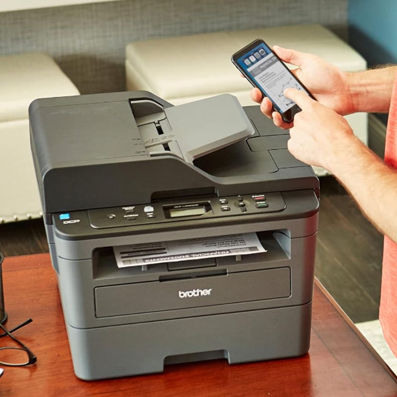 a person opening the companion app on their phone over the printer.