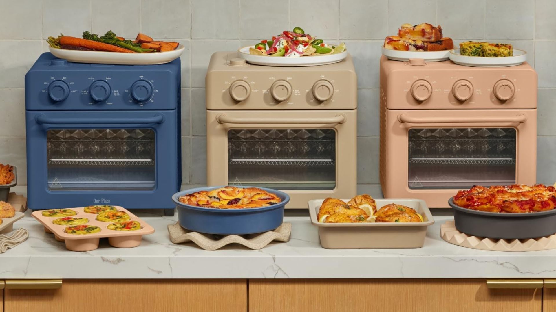 Three Wonder Ovens on a counter surrounded by food.