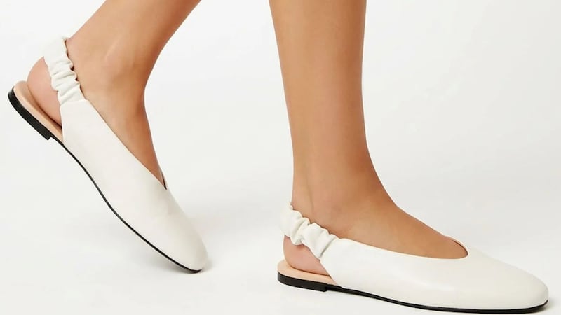 A person wearing white flats from La Canadienne