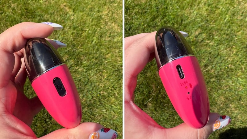 The power button on one side of the brush, and the charging port and power lights on the other