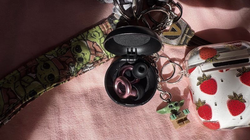 The ear plugs in their case on Bianca's keychain