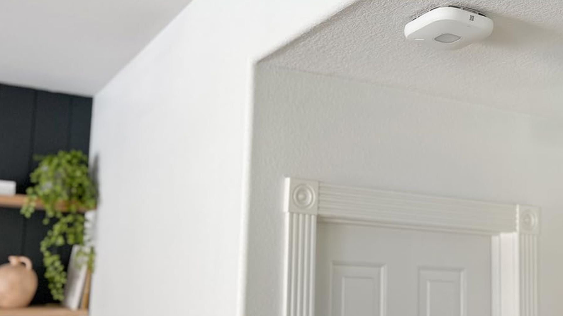 A smoke detector on a ceiling.