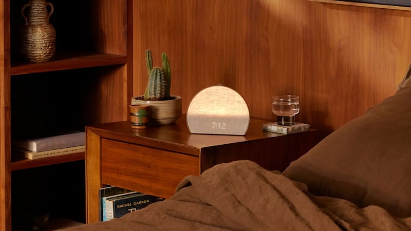 A Hatch Restore 3 Sunrise Alarm Clock on a nightstand.