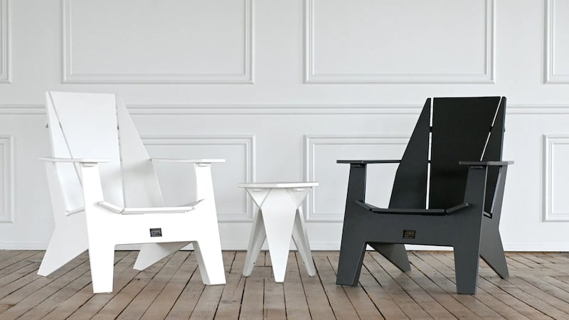 two muskoka chairs and a table in a room