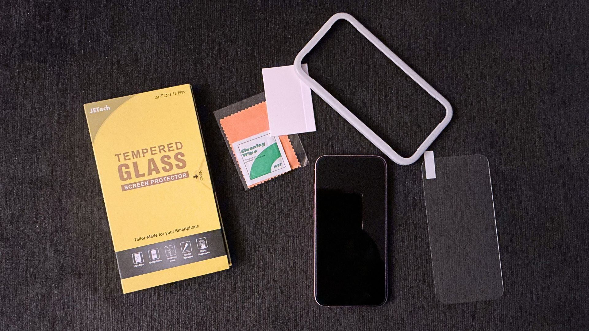 all of the things that come with the screen protectors and a cell phone with a dark background